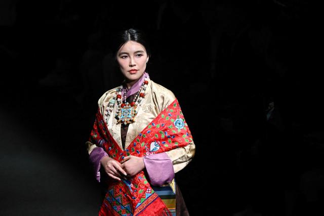 A model presents a creation by GRZG Rongrong Guo during the China Fashion Week in Beijing on March 26, 2026. (Photo by Pedro PARDO / AFP)
