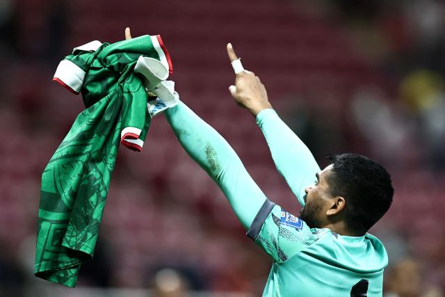New Caledonia's goalkeeper #01 Rocky Nyikeine waves to fans as he shows a Mexican national football team jersey after losing the 2026 FIFA World Cup qualifiers semi-final playoff football match between New Caledonia and Jamaica at the Akron Stadium in Zapopan, Mexico on March 26, 2026. (Photo by Ulises Ruiz / AFP)