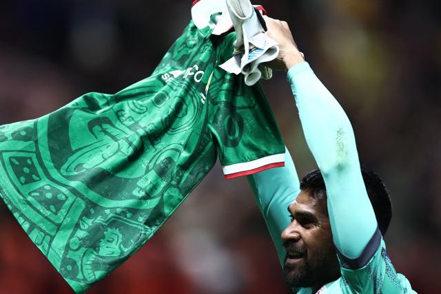 New Caledonia's goalkeeper #01 Rocky Nyikeine waves to fans as he shows a Mexican national football team jersey after losing the 2026 FIFA World Cup qualifiers semi-final playoff football match between New Caledonia and Jamaica at the Akron Stadium in Zapopan, Mexico on March 26, 2026. (Photo by Ulises Ruiz / AFP)