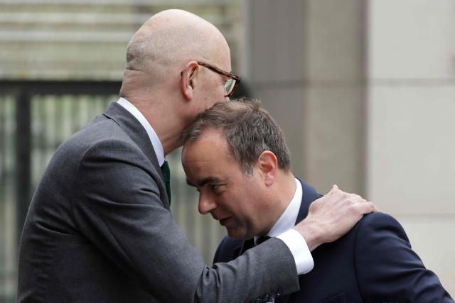 France's Prime Minister Sebastien Lecornu (R) is welcomed by France's Economy, Finances and Industry Minister Roland Lescure as he arrives at the Bercy finance ministry for a ministerial meeting to discuss public finances in Paris on March 27, 2026. (Photo by Ludovic MARIN / AFP)