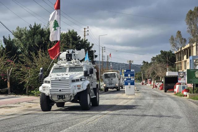 United Nations peacekeepers with the UN Interim Force in Lebanon (UNIFIL) drive past a Lebanese army outpost in the area of Naqura in southern Lebanon on March 27, 2026. Lebanon was drawn into the Middle East war on March 2 when Tehran-backed Hezbollah began firing rockets into Israel to avenge the killing of the Iranian supreme leader. Israel has since been bombing Lebanon, mainly in areas where Hezbollah has long held sway, and has sent in ground troops in a push to establish a buffer zone in south Lebanon. (Photo by KAWNAT HAJU / AFP)