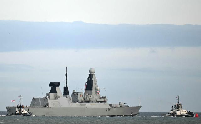 (FILES) HMS Dragon, a Royal Navy Type 45 Daring-class air-defence destroyer warship, is guided by tug boats operated by Serco Marine Services, as departs from HM Naval Base Portsmouth, on the south coast of England, on March 10, 2026. The Middle East war, launched on 28 February, is exposing the limits of Britain's navy, seen as humiliating for a country long considered a historic maritime power. Controversy about Britain's naval capabilities first erupted over the late deployment of HMS Dragon to protect British bases in Cyprus, one of which was hit by an Iranian drone. The destroyer has only just arrived. In the meantime, France deployed its Charles de Gaulle aircraft carrier, while Italy and Greece sent ships to reassure Cyprus. Right-wing newspaper the Daily Telegraph called the comparisons "embarrassing". (Photo by JUSTIN TALLIS / AFP)