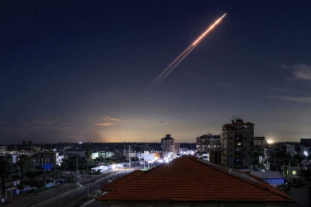 (FILES) A missile launched from Iran is pictured in the sky from the Bureij camp for Palestinian refugees in the central Gaza Strip on March 1, 2026. The United States and Israel began the war on February 28, 2026, by attacking Iran and killing its supreme leader. Iran retaliated with strikes against Israel and US allies and interests across the Gulf and Iraq, drawing the whole region into war. (Photo by Eyad Baba / AFP)