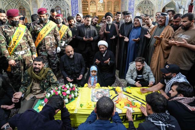 (FILES) The daughter of a member of the pro-Iranian armed group Kataeb Hezbollah, who was killed in a reported US strike in Al-Qaim, attends his funeral with other mourners at the Imam Ali shrine in Najaf on March 19, 2026. The United States and Israel began the war on February 28, 2026, by attacking Iran and killing its supreme leader. Iran retaliated with strikes against Israel and US allies and interests across the Gulf and Iraq, drawing the whole region into war. (Photo by Qassem al-KAABI / AFP)