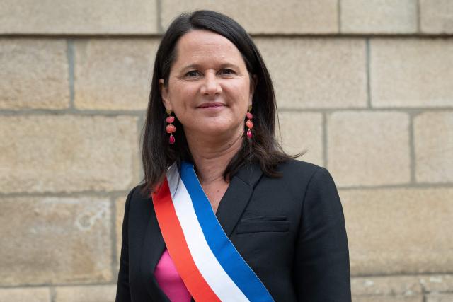 The Socialist Party (PS) mayor of Nantes Johanna Rolland poses with a tricolor scarf outside Nantes town hall, western France on March 27, 2026. (Photo by Sebastien Salom-Gomis / AFP)