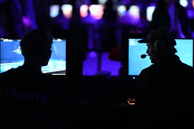 Gamers talk to eachother during DreamHack 2026 at the NEC in Birmingham, central England on March 27, 2026. (Photo by Oli SCARFF / AFP)
