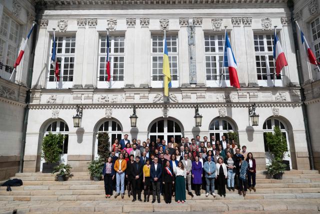 French socialist party (PS)  re-elected mayor of Nantes Johanna Rolland (C) poses with the new elected municipal council outside the town hall of Nantes , western France, on March 27, 2026. (Photo by Sebastien Salom-Gomis / AFP)