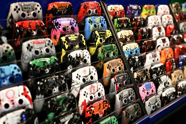 Customised PS5 controller faceplates are displayed for sale during DreamHack 2026 at the NEC in Birmingham, central England on March 27, 2026. (Photo by Oli SCARFF / AFP)