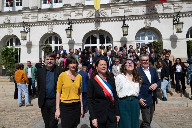 French socialist party (PS)  re-elected mayor of Nantes Johanna Rolland (C) poses with the new elected municipal council outside the town hall of Nantes, western France, on March 27, 2026. (Photo by Sebastien Salom-Gomis / AFP)