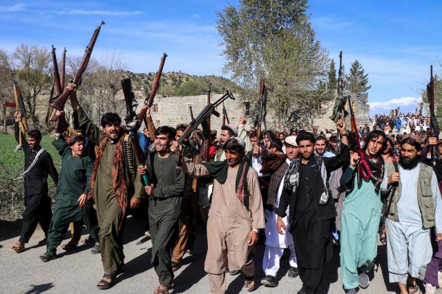Afghan men armed with guns and rifles march to show their solidarity with Taliban personnel while shouting slogans against Pakistan, in the Zazai Maidan district of Khost province on March 27, 2026. Afghanistan and Pakistan have been fighting for months over claims from Islamabad that Kabul is harbouring extremists behind cross-border attacks on its territory. (Photo by AFP)