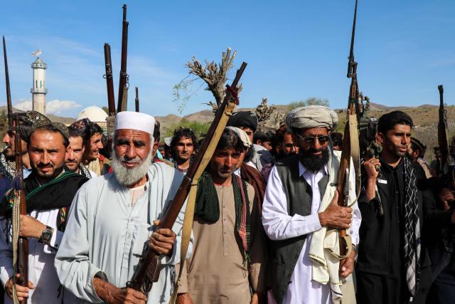 Afghan men armed with guns and rifles march to show their solidarity with Taliban personnel while shouting slogans against Pakistan, in the Zazai Maidan district of Khost province on March 27, 2026. Afghanistan and Pakistan have been fighting for months over claims from Islamabad that Kabul is harbouring extremists behind cross-border attacks on its territory. (Photo by AFP)