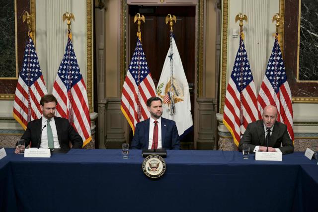 US Vice President JD Vance (C) and Andrew Ferguson (L), chairman of the Federal Trade Commission listen to Stephen Miller (R), White House Deputy Chief of Staff, as he addresses a Fraud Task Force meeting in the Indian Treaty Room at the White House in Washington, DC 27 March, 2026. (Photo by Oliver Contreras / AFP)