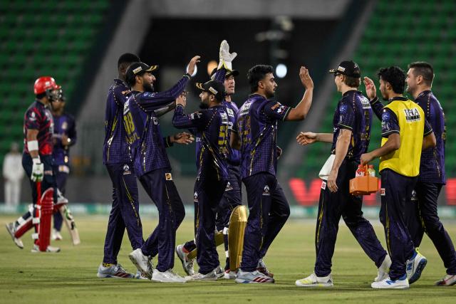Quetta Gladiator's player celebrate with teammates after the dismissal of Karachi King's UAE cricket player Muhammad Waseem during the Pakistan Super League (PSL) Twenty20 match between Karachi Kings and Quetta Gladiators at Gaddafi Stadium in Lahore on March 27, 2026. (Photo by Arif ALI / AFP)
