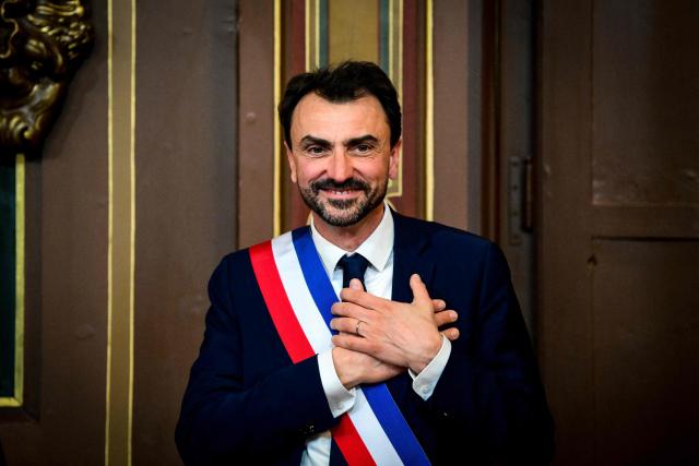 Newly re-elected Lyon mayor Gregory Doucet reacts after receiving his mayoral sash during the inaugural session of the city council, central-eastern France, on March 27, 2026. (Photo by OLIVIER CHASSIGNOLE / AFP)