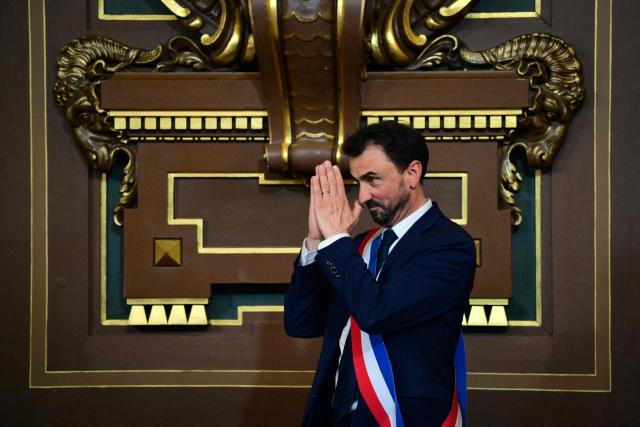 Newly re-elected Lyon mayor Gregory Doucet reacts after receiving his mayoral sash during the inaugural session of the city council, central-eastern France, on March 27, 2026. (Photo by OLIVIER CHASSIGNOLE / AFP)