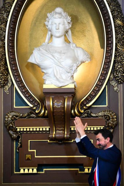 Newly re-elected Lyon mayor Gregory Doucet reacts after receiving his mayoral sash during the inaugural session of the city council, central-eastern France, on March 27, 2026. (Photo by OLIVIER CHASSIGNOLE / AFP)