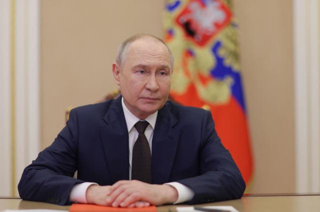 In this pool photograph distributed by the Russian state agency Sputnik, Russia's President Vladimir Putin holds an operational meeting with permanent members of the Security Council of the Russian Federation via videoconference in Moscow on March 27, 2026. (Photo by Gavriil Grigorov / POOL / AFP)