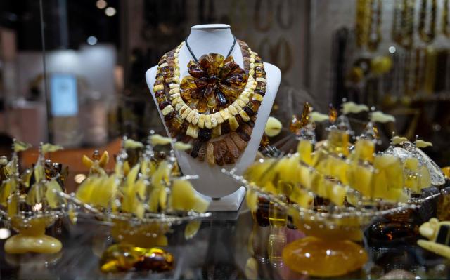 This photo taken on March 27, 2026 shows jewellery and other items made of Baltic amber displayed at the Amberif Fair in Gdansk. Around 200 exhibitors takes part in this year’s Amberif, a fair held annually in Gdansk where entrepreneurs, craftsmen and artists from all over the world who work with amber can sell or buy amber, establish new contracts or simply showcase their offerings. (Photo by Wojtek RADWANSKI / AFP)
