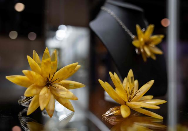 This photo taken on March 27, 2026 shows jewellery made of Baltic amber displayed at the Amberif Fair in Gdansk. Around 200 exhibitors takes part in this year’s Amberif, a fair held annually in Gdansk where entrepreneurs, craftsmen and artists from all over the world who work with amber can sell or buy amber, establish new contracts or simply showcase their offerings. (Photo by Wojtek RADWANSKI / AFP)