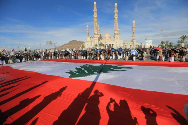 Houthis rally in solidarity with Iran and Lebanon, amid the US-Israeli war with Iran, in the Yemeni capital Sanaa on March 27, 2026. Abdul Malik al-Houthi, leader of Yemen's Iran-backed Houthi movement, warned on March 26 of a "military response" should the Middle East war require it. The Houthis, a key part of Iran's so-called "axis of resistance", have so far refrained from joining the war sparked by US-Israeli strikes on Iran, which has engulfed much of the region. (Photo by Mohammed HUWAIS / AFP)