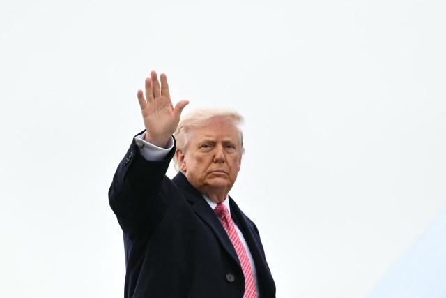 US President Donald Trump waves as he boards Air Force One at Joint Base Andrews in Maryland on March 27, 2026. Trump is heading to Miami to speak at a Summit before spending the weekend at his Mar-a-Lago resort. (Photo by Mandel NGAN / AFP)