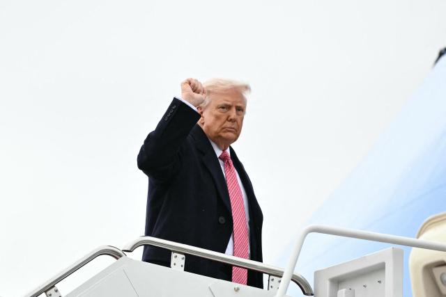 US President Donald Trump pumps his fist as he boards Air Force One at Joint Base Andrews in Maryland on March 27, 2026. Trump is heading to Miami to speak at a Summit before spending the weekend at his Mar-a-Lago resort. (Photo by Mandel NGAN / AFP)