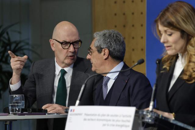 France's Economy, Finances and Industry Minister Roland Lescure (L) and France's Trade Minister Serge Papin speak together as France's Government Spokesperson and junior Minister for Energy and Digital economy Maud Bregeon (R) delivers a speech during a presentation of a support plan for the activity of the economic sectors most affected by the energy crisis at the Bercy finance ministry in Paris on March 27, 2026. (Photo by Ludovic MARIN / AFP)
