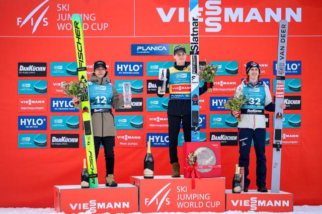 (From L) Second placed Japan’s Ren Nikaido, winner Slovenia’s Domen Prevc and third placed Austria’s Daniel Tschofenig pose for photos on the podium of the Men Individual Flying Hill competition of the FIS Ski Jumping World Cup in Planica, Slovenia on March 27, 2026. (Photo by Jure Makovec / AFP)