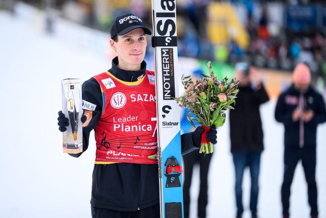 Slovenia’s Domen Prevc poses with his trophy after winning the Men Individual Flying Hill competition of the FIS Ski Jumping World Cup in Planica, Slovenia on March 27, 2026. (Photo by Jure Makovec / AFP)