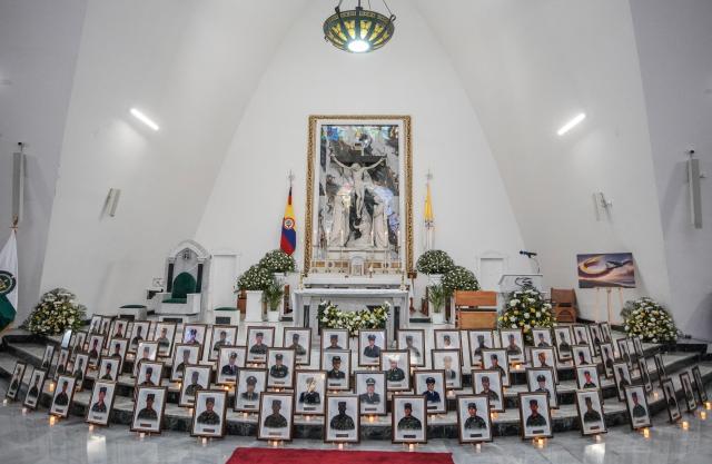 Portraits of the 69 soldiers and police officers who died in an Air Force Hercules accident are displayed during a religious ceremony in Bogota on March 27, 2026. The death toll in one of Colombia's worst air accidents in recent years rose to at least 69, according to an updated tally on March 24, as the government faulted a "junk" aircraft donated by the United States. (Photo by Sergio Yate / AFP)