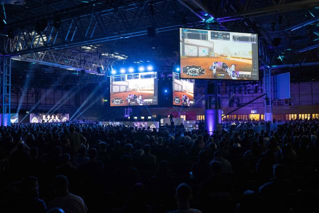 Specataors watch a competivive Call of Duty eSports match between Gentlemates and Royal Ravens at the DreamHack 2026 gaming convention at the NEC in Birmingham, central England on March 27, 2026. (Photo by Oli SCARFF / AFP)