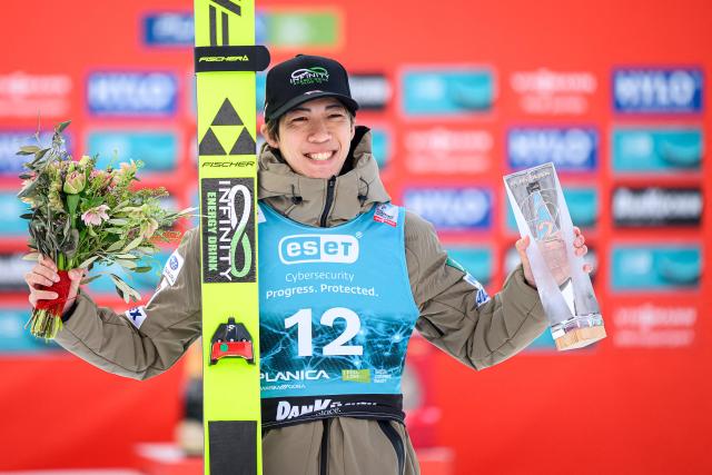 Japan’s Ren Nikaido poses with his trophy after placing second in the Men Individual Flying Hill competition of the FIS Ski Jumping World Cup in Planica, Slovenia on March 27, 2026. (Photo by Jure Makovec / AFP)