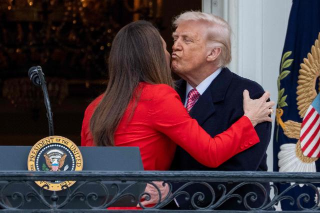 US Secretary of Agriculture Brooke Rollins gets a kiss from US President Donald Trump after delivering remarks to farmers from the Truman balcony of the White House in Washington, DC, on March 27, 2026. (Photo by Ken Cedeno / AFP)