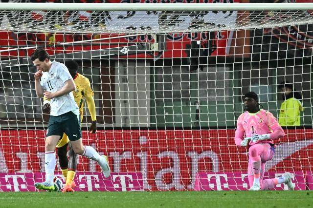 Austria's forward #11 Michael Gregoritsch (L) celebrates after scoring the 2-0 goal as Ghana's goalkeeper #01 Lawrence Ati-Zigi (R) reacts during the friendly football match Austria vs Ghana in Vienna, Austria, on March 27, 2026. (Photo by Joe Klamar / AFP)