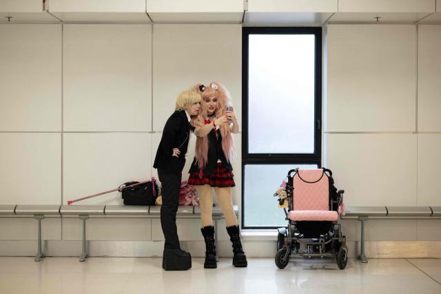 Cosplayers take a selfie as they attend the DreamHack 2026 gaming convention at the NEC in Birmingham, central England on March 27, 2026. (Photo by Oli SCARFF / AFP)