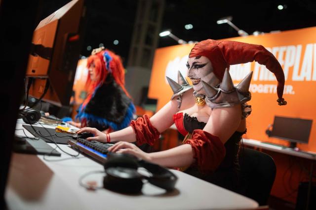 Cosplaying gamers representing Shaco (R) and Gnar (L) play League of Legends during the DreamHack 2026 gaming convention at the NEC in Birmingham, central England on March 27, 2026. (Photo by Oli SCARFF / AFP)