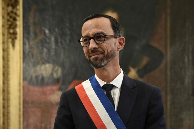 Pau's new Mayor Jerome Marbot reacts after receiving the tricolour mayoral sash during his installation as Mayor of Pau at the City Hall (Hotel de Ville) of Pau, south-western France, on March 27, 2026. Marbot, a public and environmental law attorney, defeated outgoing MoDem leader Francois Bayrou by 344 votes in the second round of municipal elections on March 22. (Photo by Philippe LOPEZ / AFP)