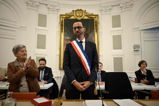 Pau's new Mayor Jerome Marbot reacts after receiving the tricolour mayoral sash during his installation as Mayor of Pau at the City Hall (Hotel de Ville) of Pau, south-western France, on March 27, 2026. Marbot, a public and environmental law attorney, defeated outgoing MoDem leader Francois Bayrou by 344 votes in the second round of municipal elections on March 22. (Photo by Philippe LOPEZ / AFP)