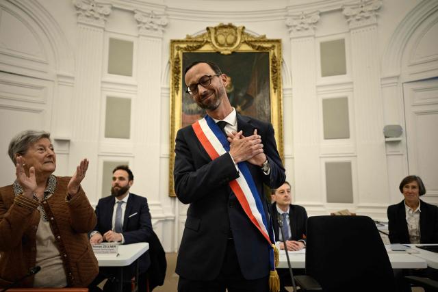 Pau's new Mayor Jerome Marbot reacts after receiving the tricolour mayoral sash during his installation as Mayor of Pau at the City Hall (Hotel de Ville) of Pau, south-western France, on March 27, 2026. Marbot, a public and environmental law attorney, defeated outgoing MoDem leader Francois Bayrou by 344 votes in the second round of municipal elections on March 22. (Photo by Philippe LOPEZ / AFP)