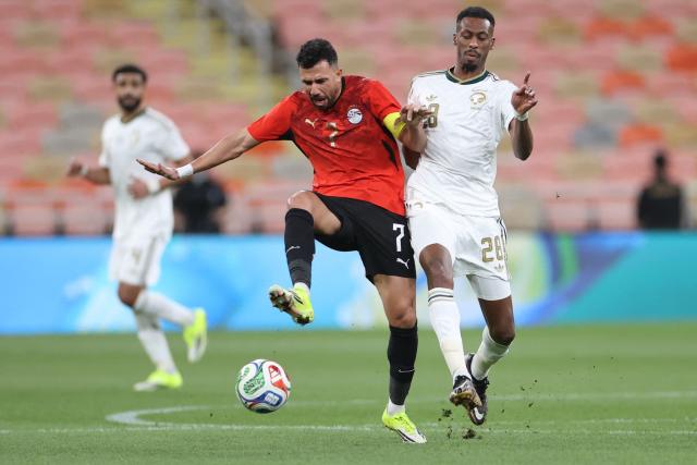 Egypt's forward #7 Mahmoud Trezeguet fights for the ball with Saudi Arabia's midfielder #28 Mohamed Kanno during the friendly football match between Saudi Arabia and Egypt at King Abdullah Sports City in Jeddah on March 27, 2026. (Photo by AFP)