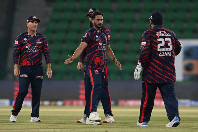 Karachi kings' Hassan Ali celebrates with teammates after taking the wicket of Quetta Gladiators' Tom Curran during the Pakistan Super League (PSL) Twenty20 cricket  match between Karachi Kings and Quetta Gladiators at the Qaddafi Cricket Stadium in Lahore on March 27, 2026. (Photo by Arif ALI / AFP)