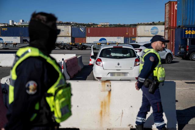 French customs' officers patrol during the visit of France's junior Minister for Public Accounts at the Grand Port Maritime of Marseille, southeastern France on March 27, 2026.  (Photo by MIGUEL MEDINA / AFP)