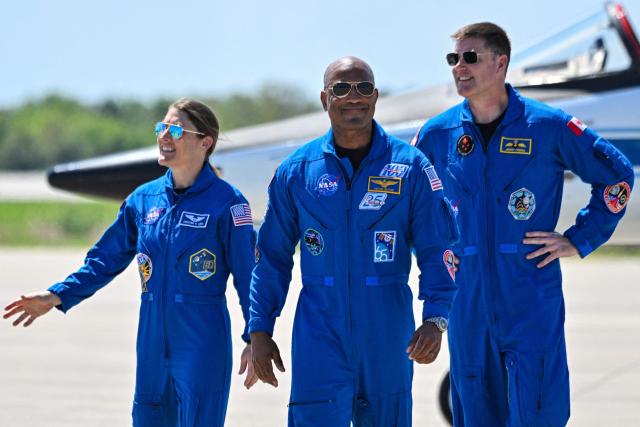 (L-R) NASA astronaut and Artemis II Mission Specialist Christina Koch, NASA Artemis II, NASA astronaut and Artemis II pilot Victor Glover and Canadian Space Agency astronaut Mission Specialist Jeremy Hansen, look on during a welcome ceremony ahead of the Artemis II April 1 launch at Kennedy Space Center in Florida on March 27, 2026.


NASA astronauts assigned to the Artemis II mission arrive at Kennedy Space Center in Florida on March 27, 2026, to begin final pre-launch preparations for the first crewed lunar flyby in the Artemis program.. The journey, set to last around 10 days, will take the astronauts on a loop around the Moon, though they will not land on its surface. The crew comprises the first woman, the first person of color and the first non-American to take part in such a journey. (Photo by Miguel J Rodriguez Carrillo / AFP)
