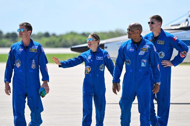 (L-R) NASA astronaut and Artemis II Commander Reid Wiseman, NASA astronaut and Artemis II Mission Specialist Christina Koch, NASA Artemis II, NASA astronaut and Artemis II pilot Victor Glover and Canadian Space Agency astronaut Mission Specialist Jeremy Hansen, look on during a welcome ceremony ahead of the Artemis II April 1 launch at Kennedy Space Center in Florida on March 27, 2026.


NASA astronauts assigned to the Artemis II mission arrive at Kennedy Space Center in Florida on March 27, 2026, to begin final pre-launch preparations for the first crewed lunar flyby in the Artemis program.. The journey, set to last around 10 days, will take the astronauts on a loop around the Moon, though they will not land on its surface. The crew comprises the first woman, the first person of color and the first non-American to take part in such a journey. (Photo by Miguel J Rodriguez Carrillo / AFP)