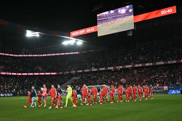 Switzerland and Germany's starting squads arrive on the pitch ahead of the start of the international friendly football match between Switzerland and Germany at St.Jakob-Park in Basel, Switzerland on March 27, 2026. (Photo by Fabrice COFFRINI / AFP)