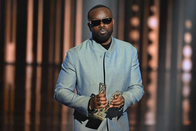 (FILES) Congolese singer Gims celebrates as he receives the Best Male Artist award during the 40th Victoires de la Musique, the annual French music awards ceremony, at the Seine Musicale concert hall in Boulogne-Billancourt, on the outskirts of Paris, on February 14, 2025. indicted on March 27, 2026, on charges including aggravated money laundering, according to the national organised crime prosecutor's office. (Photo by Bertrand GUAY / AFP)