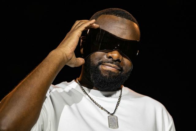 (FILES) Congolese singer, rapper, and singer-songwriter GIMS, formerly known as Maître Gims performs at the Golden Coast rap festival in Corcelles-les-Monts near Dijon, central eastern France, on September 6, 2025. The Congolese singer Gims, France's most-listened artist in 2025, was indicted on March 27, 2026, on charges including aggravated money laundering, according to the national organised crime prosecutor's office. (Photo by ARNAUD FINISTRE / AFP)