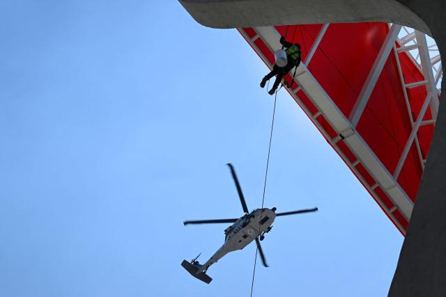 A helicopter of the National Guard flies over the newly renovated Banorte Stadium, formerly the Azteca Stadium, in Mexico City on March 27, 2026. (Photo by Alfredo ESTRELLA / AFP)