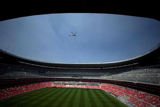 A helicopter of the National Guard flies over the newly renovated Banorte Stadium, formerly the Azteca Stadium, in Mexico City on March 27, 2026. (Photo by Alfredo ESTRELLA / AFP)