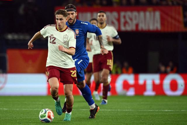 Spain's forward #22 Fermin Lopez is challenged by Serbia's midfielder #06 Nemanja Gudelj during the international friendly football match between Spain and Serbia at La Ceramica Stadium in Vila-real on March 27, 2026. (Photo by JOSE JORDAN / AFP)